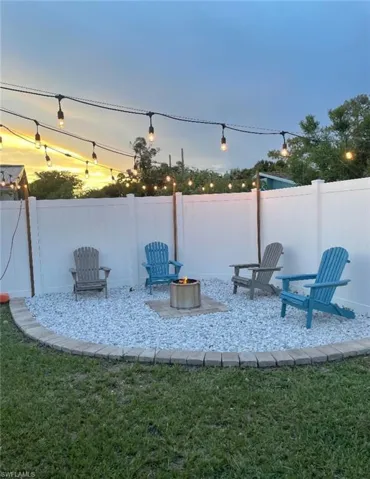 Yard at dusk featuring a fire pit