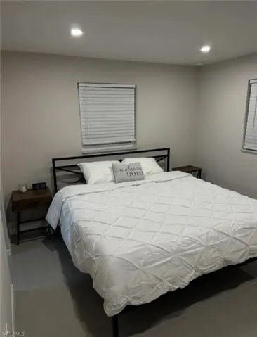 Bedroom with concrete flooring