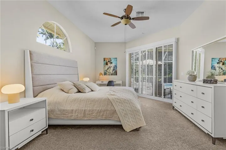 Bedroom featuring a ceiling fan, light colored carpet, access to outside, and visible vents