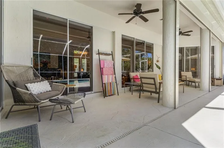 View of patio with outdoor lounge area and ceiling fan