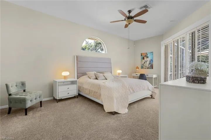 Bedroom with ceiling fan, visible vents, baseboards, and carpet flooring