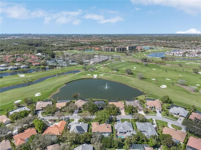 Bird's eye view with golf course view, a water view, and a residential view
