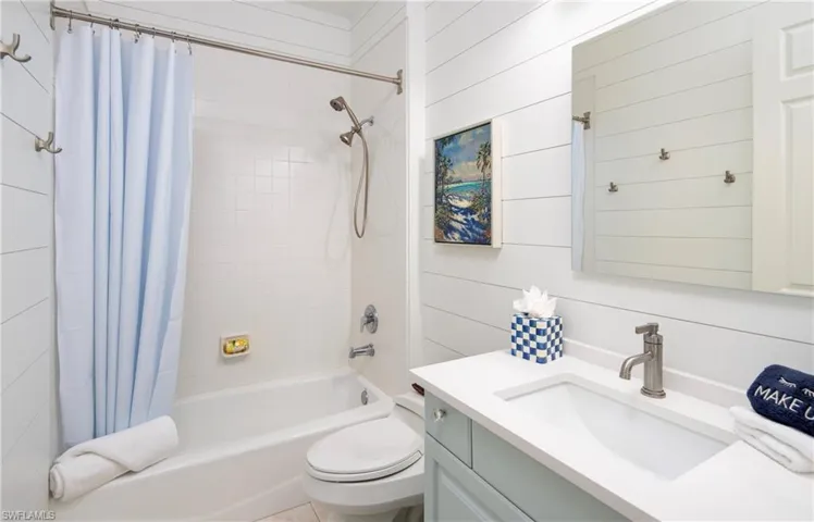 Full bath featuring shower / bath combo with shower curtain, vanity, and toilet