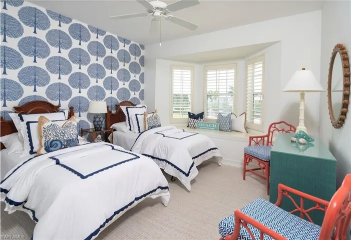 Bedroom with carpet floors, ceiling fan, and baseboards