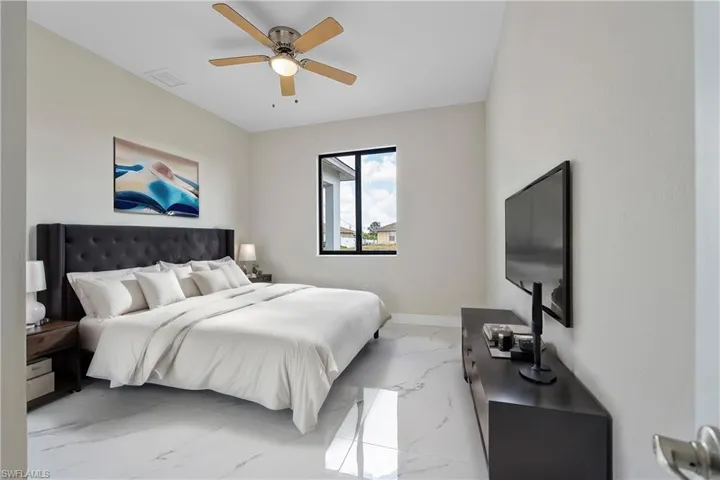Bedroom featuring tile patterned flooring and ceiling fan