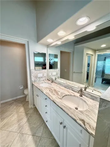 Full bathroom featuring double vanity and recessed lighting