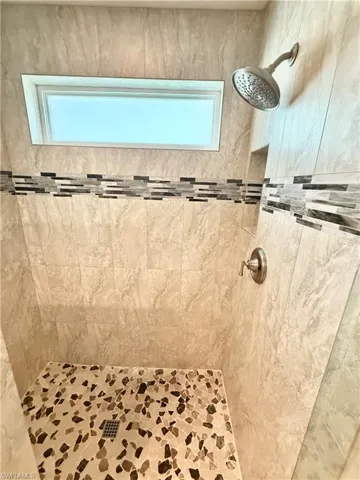 Full bathroom featuring a shower stall