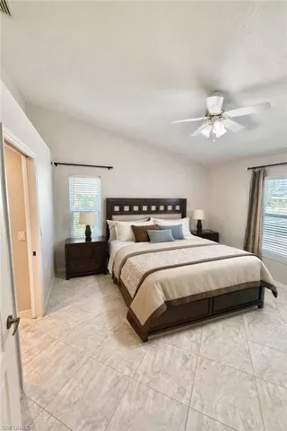 Bedroom with lofted ceiling and a ceiling fan