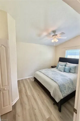 Bedroom with light wood-style flooring and a ceiling fan