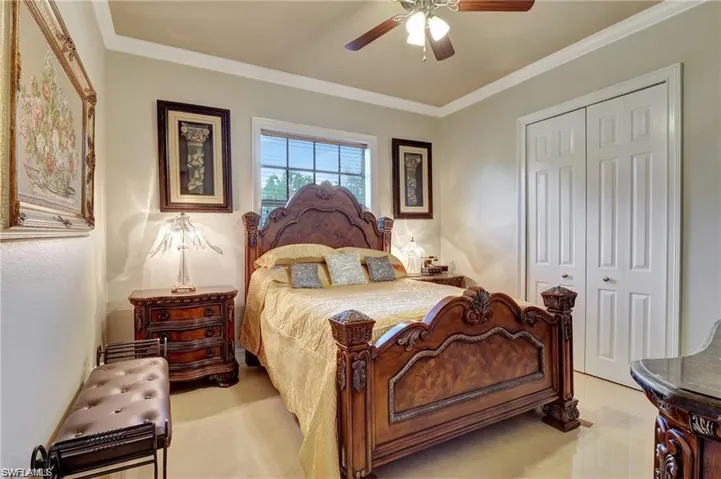 Bedroom with ornamental molding, a closet, and ceiling fan