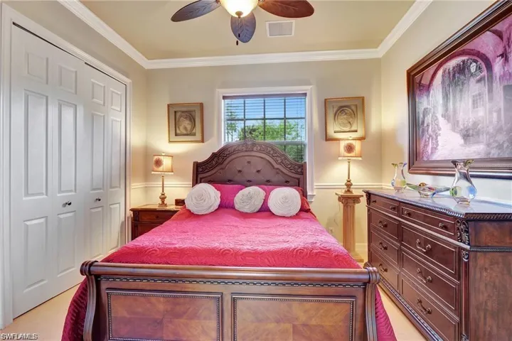 Bedroom featuring visible vents, a ceiling fan, ornamental molding, and a closet