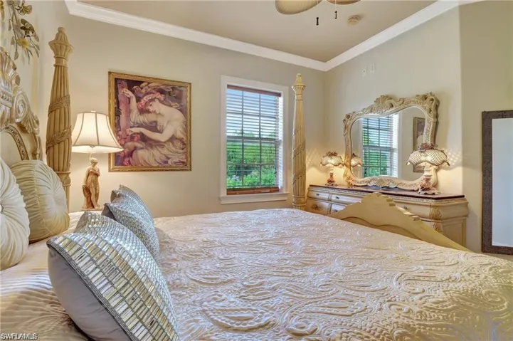 Bedroom featuring ceiling fan and crown molding