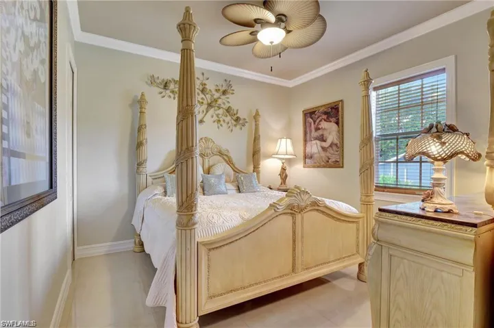 Bedroom with ornamental molding and baseboards