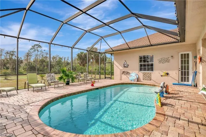 Outdoor pool with a lanai and a patio