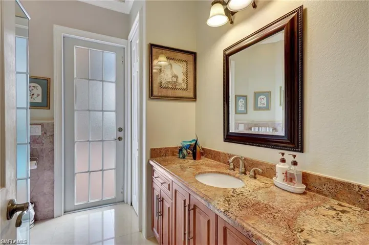 Bathroom with tile patterned floors and vanity