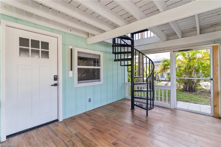 Unfurnished sunroom with beam ceiling