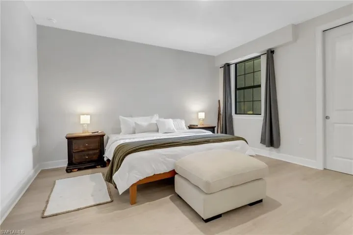 Bedroom with light wood-style flooring and baseboards