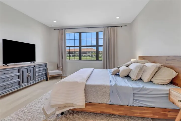 Bedroom with wood finished floors and recessed lighting