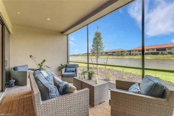 Sunroom featuring an outdoor living space and a water view