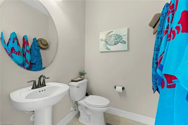 Air conditioned pool bath on the lanai with a pedestal sink.