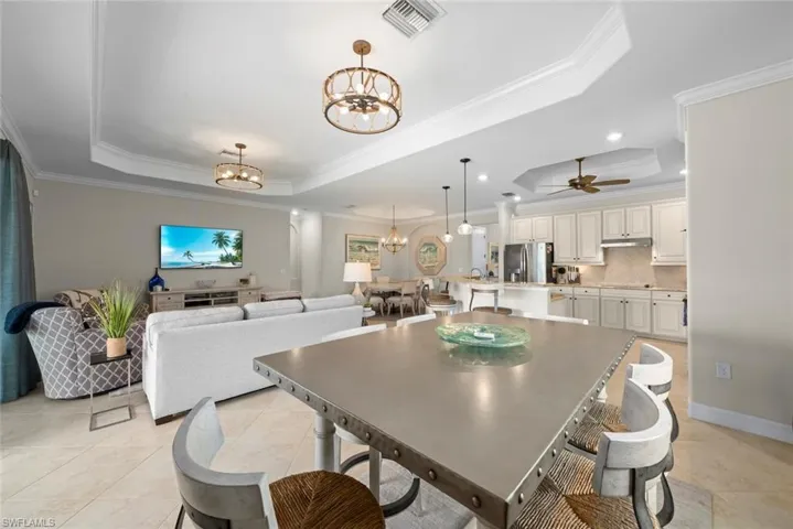 Dining area featuring table, chairs, new light fixture, and tray ceilings.