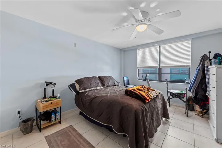 Bedroom featuring light tile patterned floors and ceiling fan