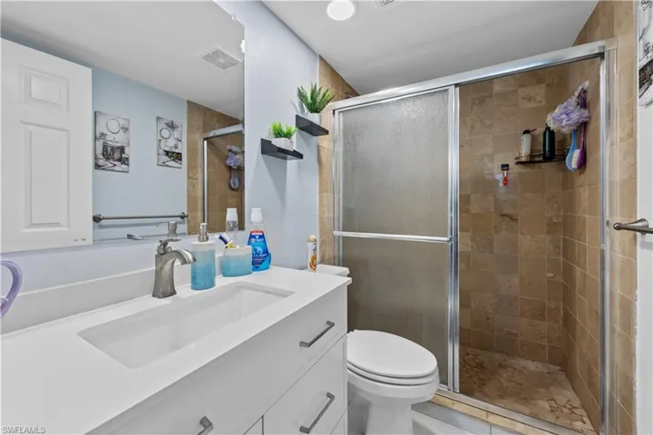 Full bath featuring vanity and a stall shower