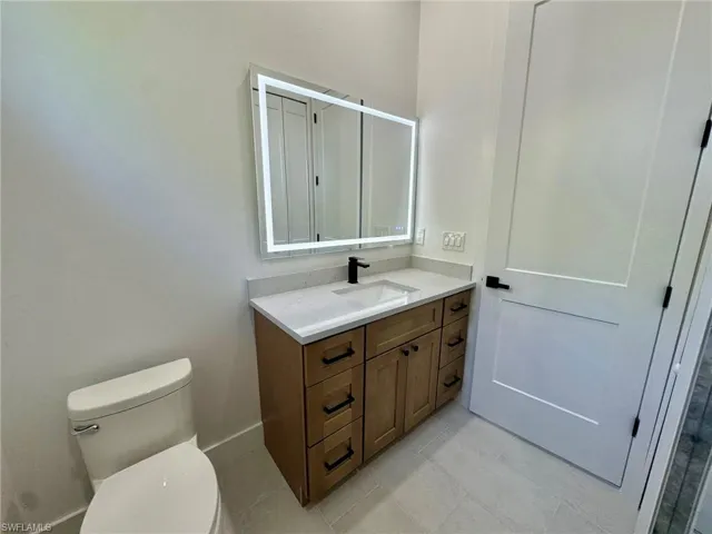 Bathroom featuring vanity and light tile patterned floors