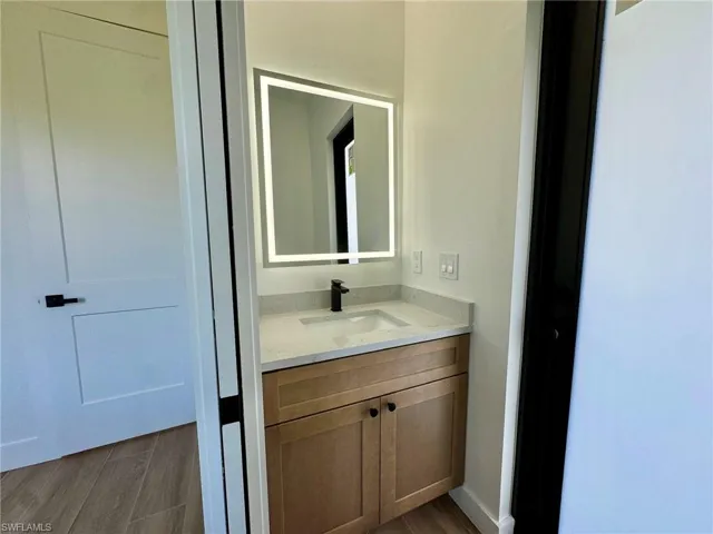 Bathroom featuring vanity and wood finished floors
