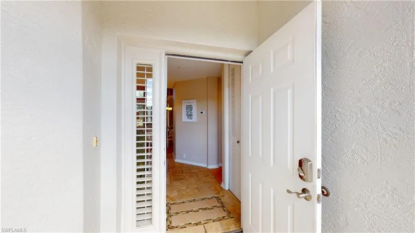 Hallway featuring a textured wall