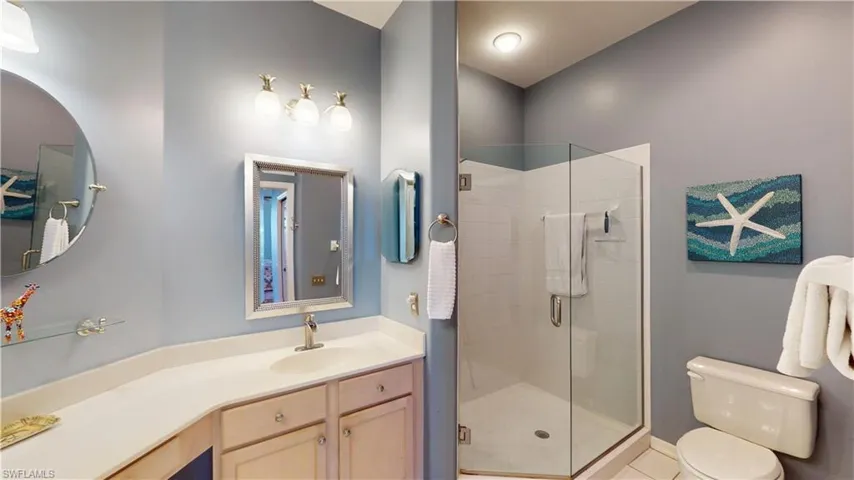Primary Full bathroom with a stall shower, vanity, and tile patterned flooring
