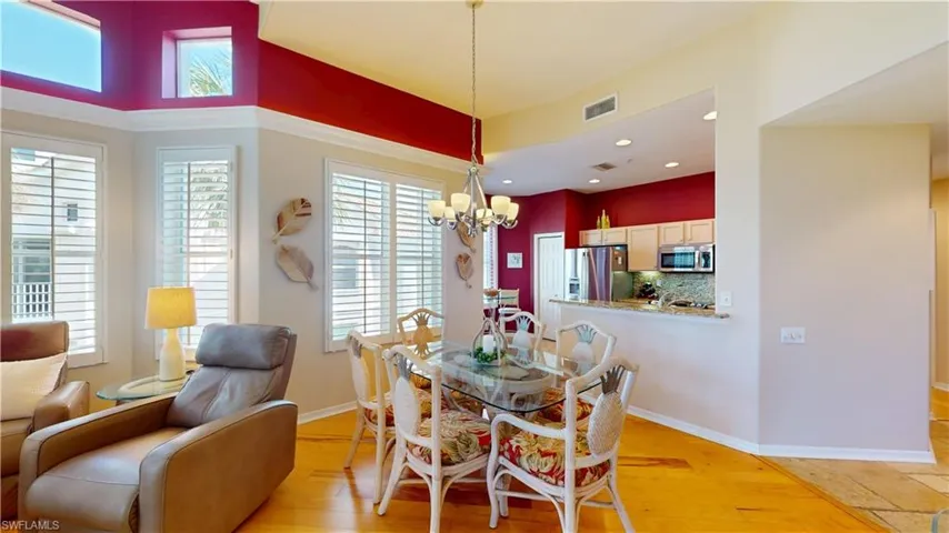 Dining area with light hardwood flooring, a chandelier, and recessed lighting