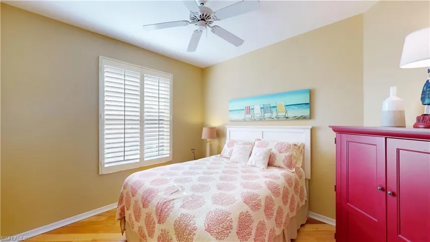 Bedroom with light hardwood flooring and a ceiling fan