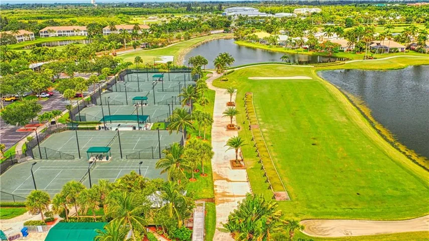 Aerial perspective of suburban area with a nearby body of water and a golf club