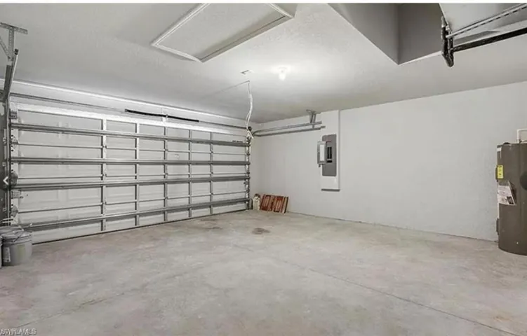 Garage with electric water heater and electric panel