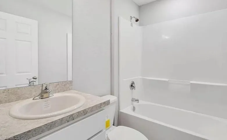 Full bath featuring vanity and  shower combination