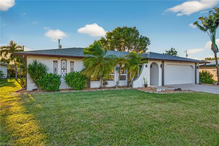 Single story home featuring stucco siding, a front lawn, concrete driveway, a garage, and a shingled roof