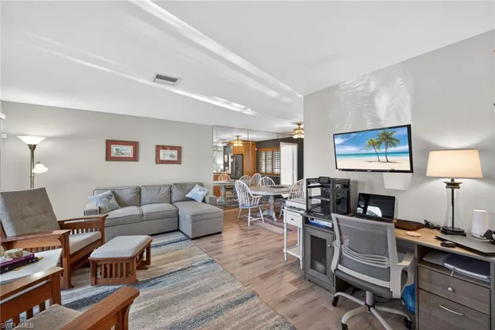 Office space with light wood-type flooring and a ceiling fan