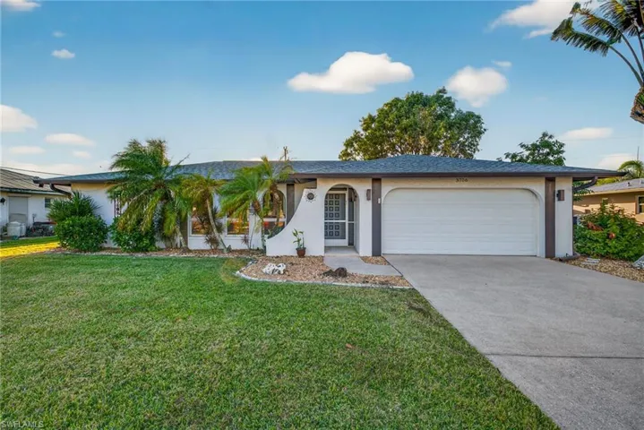 Ranch-style home featuring stucco siding, concrete driveway, a front lawn, an attached garage, and roof with shingles
