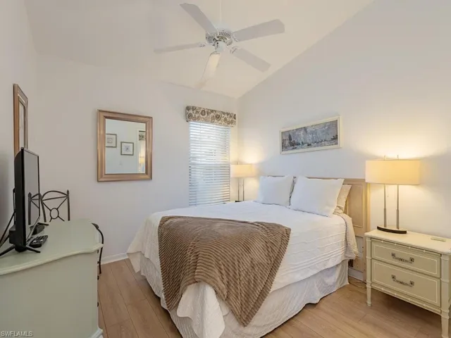 Bedroom featuring light wood-type flooring, ceiling fan, and lofted ceiling