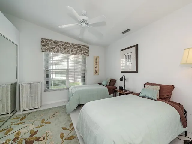 Bedroom with ceiling fan and lofted ceiling