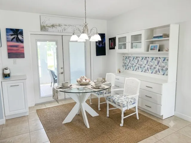 Virtually Staged Bright dining area featuring tile flooring and a woven area rug