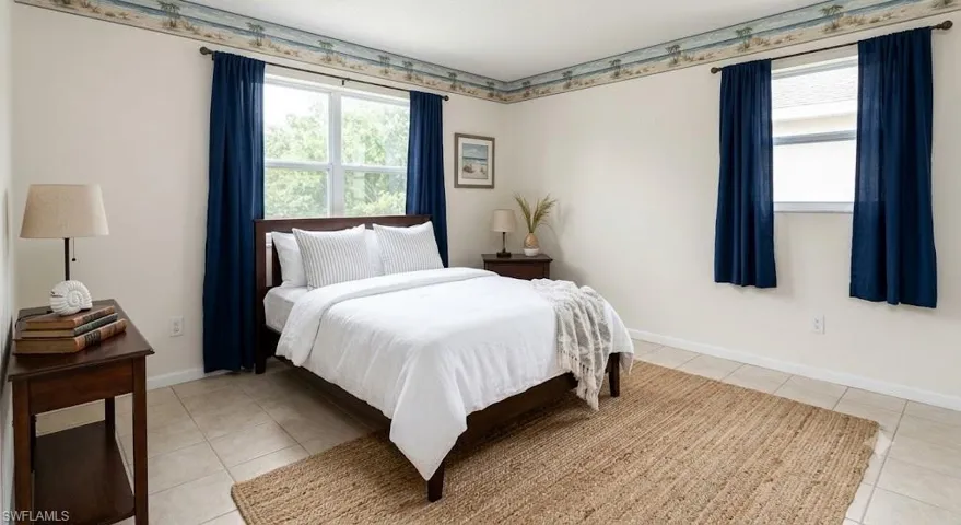 Virtually Staged Bedroom with two windows featuring dark blue drapes, light-colored wall paint, and floor tiling