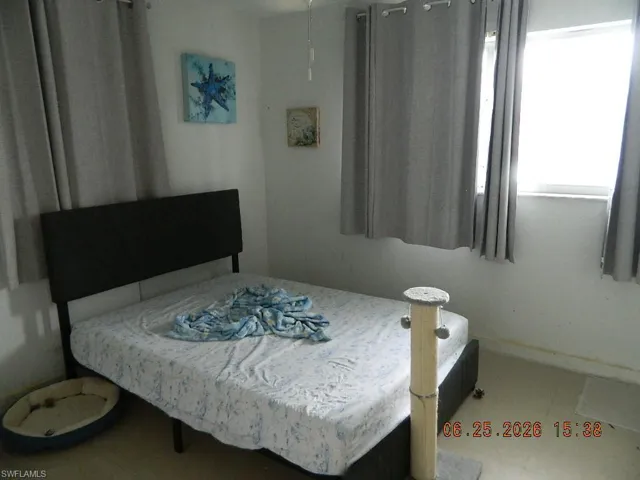 Room featuring two windows, light-colored walls, and a ceiling fan
