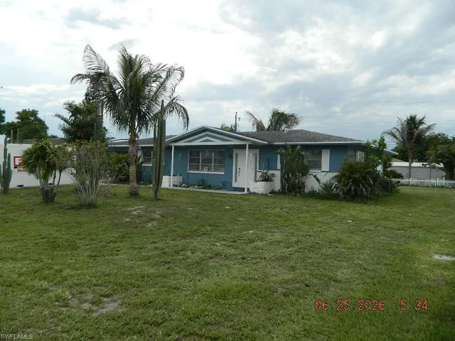 Single-story residence featuring a gabled roof and light blue siding