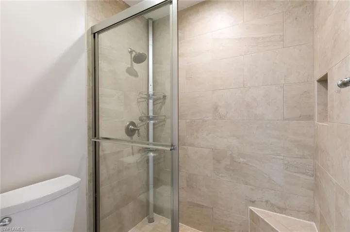 Bathroom with a stall shower and toilet