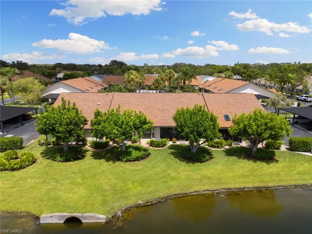 Aerial perspective of suburban area featuring a nearby body of water