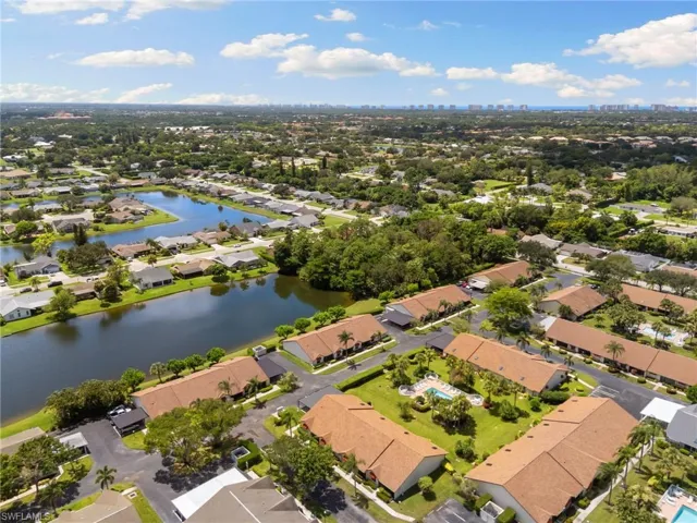 Aerial view of property and surrounding area with nearby suburban area and a nearby body of water