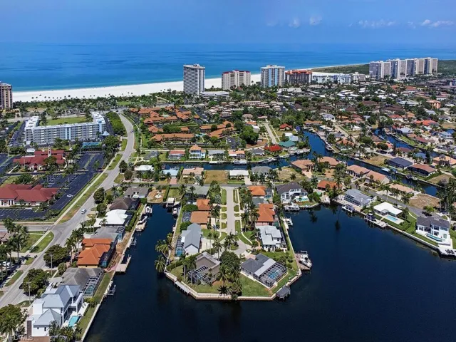 Drone / aerial view with a view of the beach and a water view