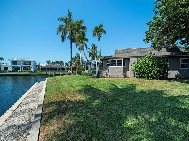 View of yard featuring a lanai and a water view